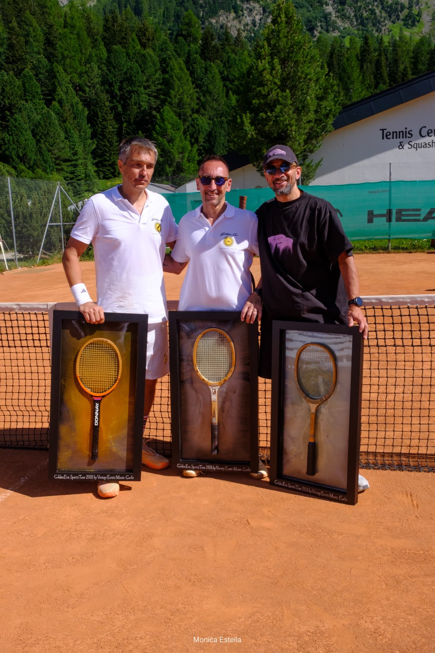 Golden Era participants presenting framed heritage tennis racquets